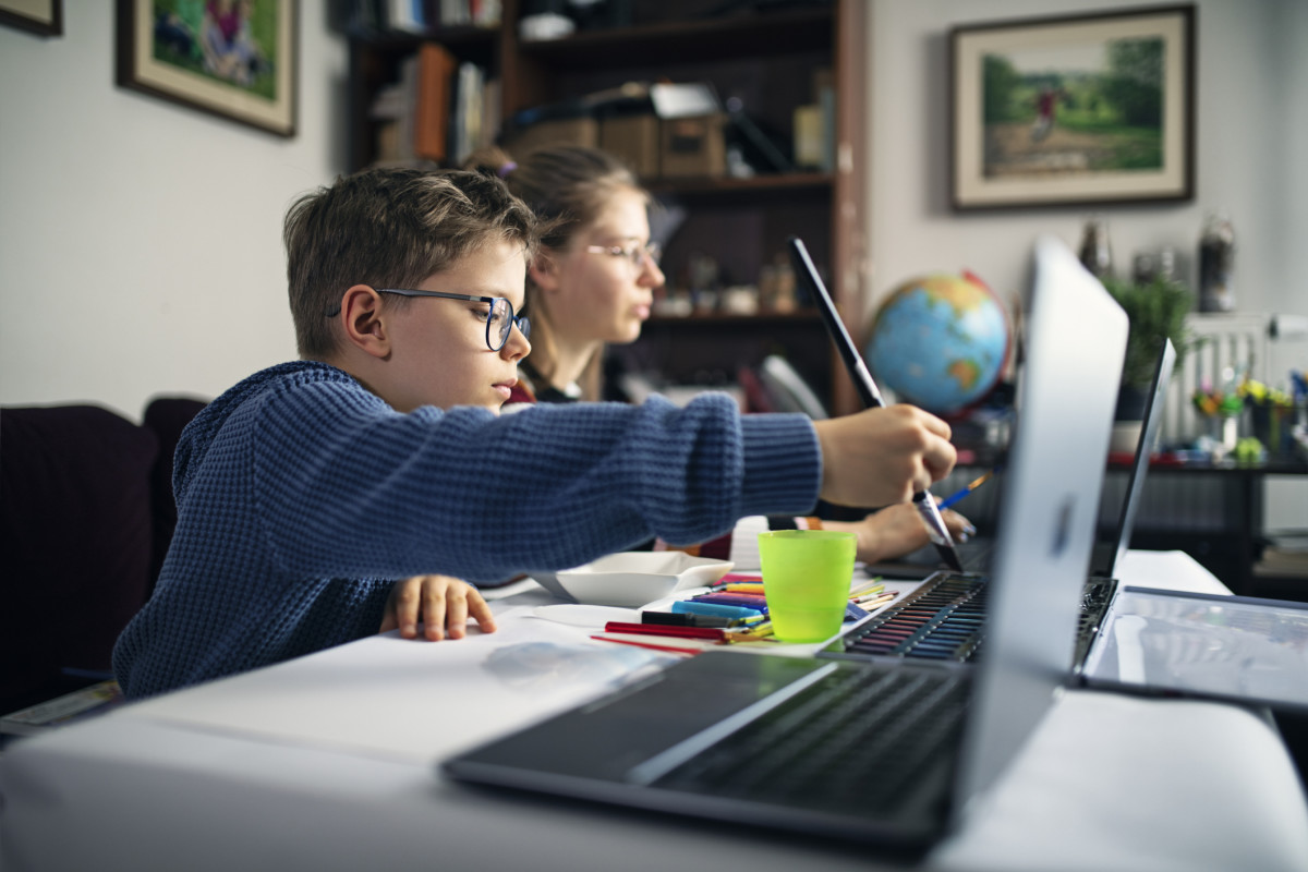 A student painting and Learning on the computer