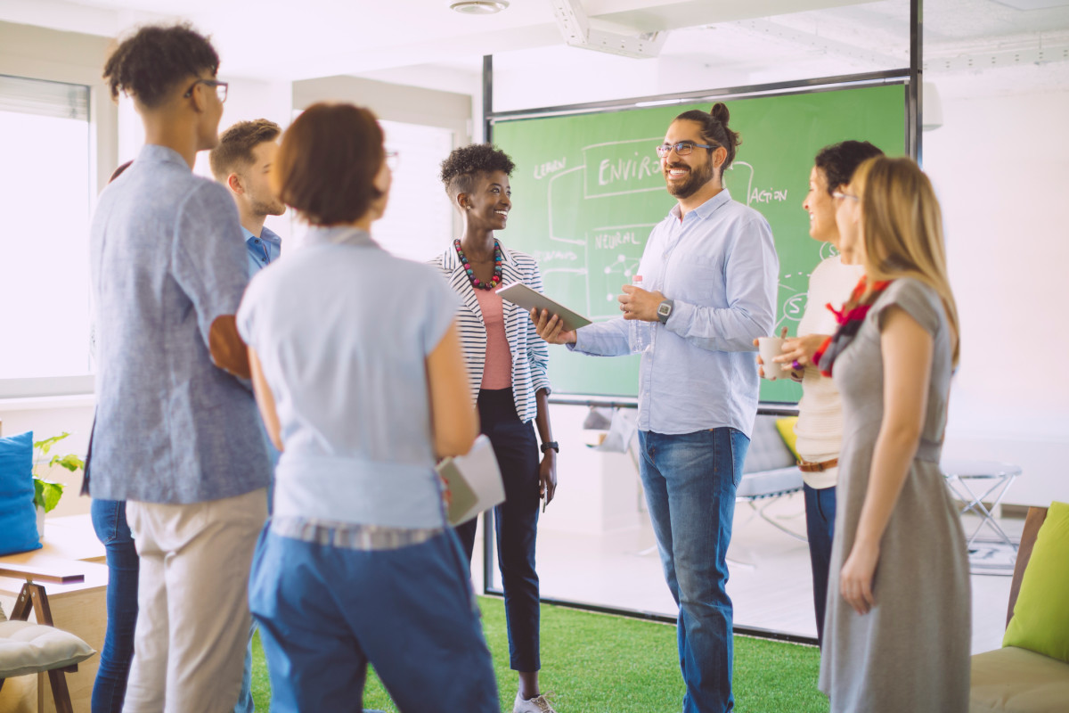 A team of teachers meeting in a classroom and talking