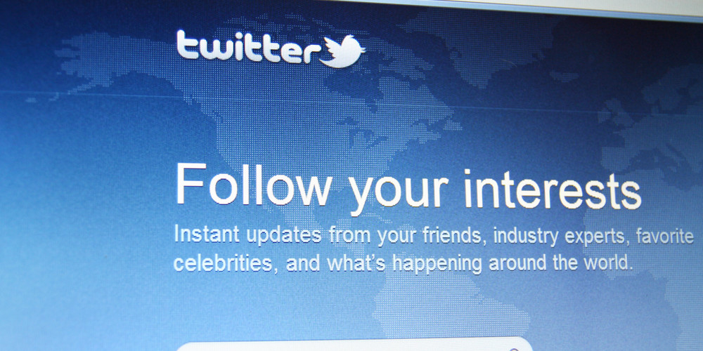 A screen with the Twitter logo that says "Follow your interests"