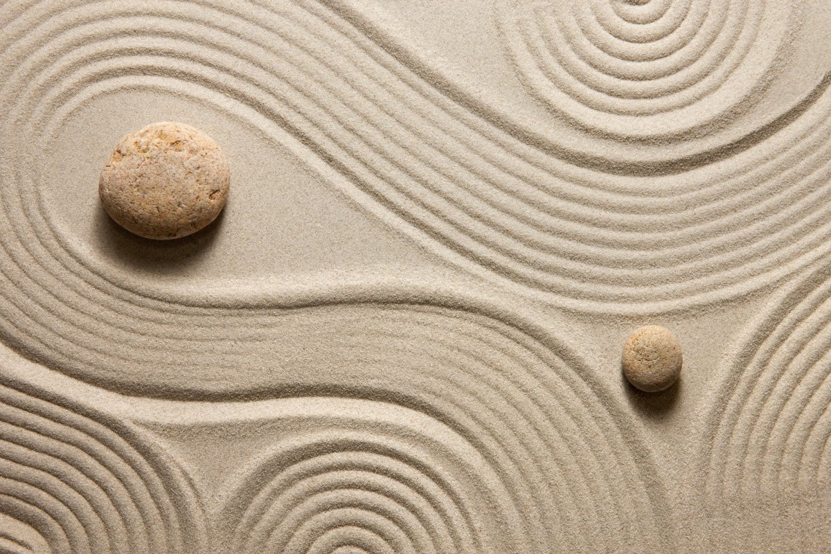 A photo of a zen sand garden with two rocks