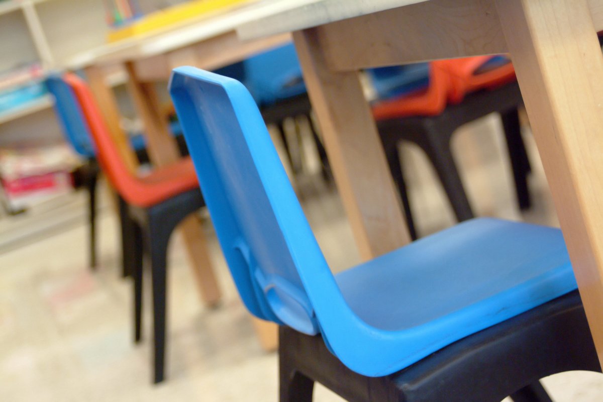 Empty student chairs in a classroom