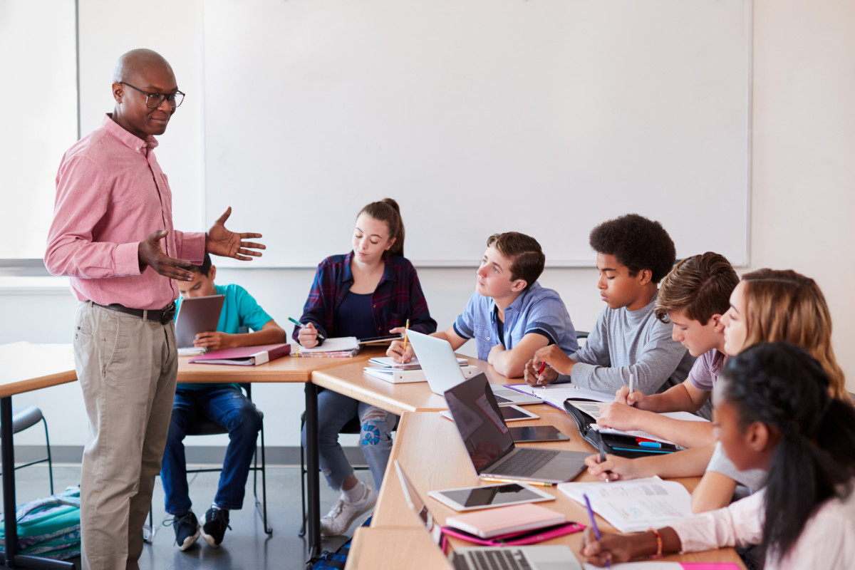 Teacher and students with technology in classroom